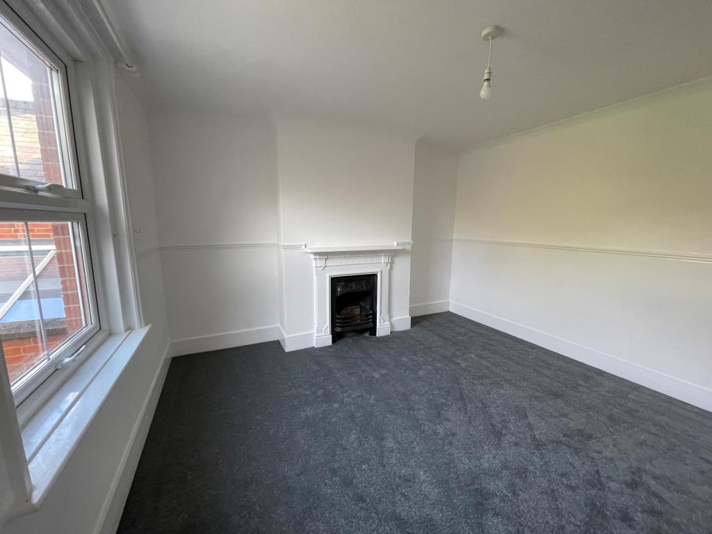 Lot: 111 - WELL PRESENTED MID-TERRACE HOUSE - Bedroomwith grey carpet, white walls and victorian fireplace